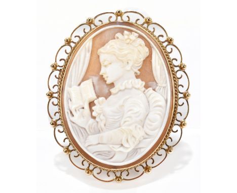 A 9ct gold cameo brooch carved with a portrait of a women reading a book, 2.5cm, approx weight 19.6g.&nbsp;