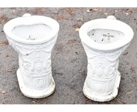Two vintage 'deluge' white ceramic and relief decorated toilets.