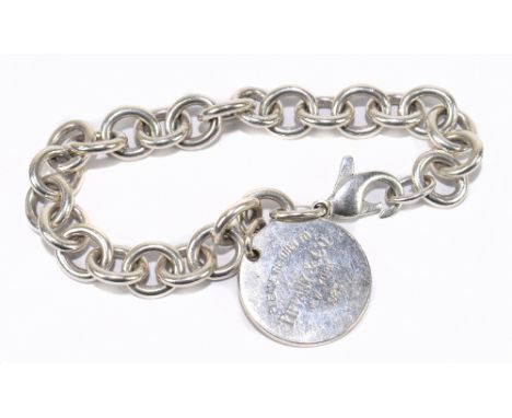 TIFFANY &amp; CO; a sterling silver bracelet with lobster claw clasp and 'dog tag', length 18cm, sold with pouch and box.&nbs