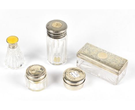 J&amp;R GRIFFIN; a George V hallmarked silver pill box of circular form, Chester 1911, and four glass dressing table bottles,