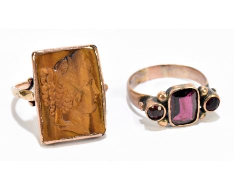 A 19th century garnet set yellow metal ring, with a yellow metal and tiger's eye cameo ring, sizes N/O and Q/P&nbsp; gross we