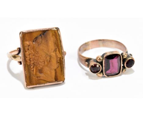 A 19th century garnet set yellow metal ring, with a yellow metal and tiger's eye cameo ring, sizes N/O and Q/P&nbsp; gross we