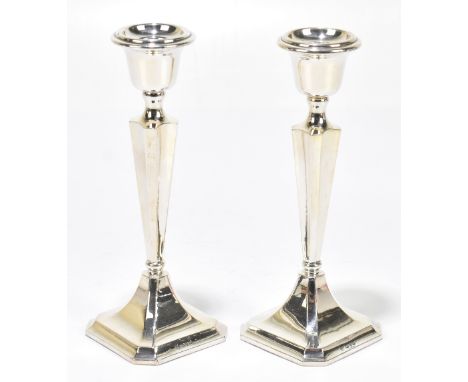 JAMES DEAKIN &amp; SONS; a pair of George V hallmarked silver candlesticks of square form, Chester 1919, height 18cm (weighte