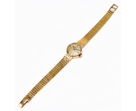 OMEGA; a lady's 9ct yellow gold wristwatch with baton markers to the circular dial and integral bracelet, length 15cm, approx