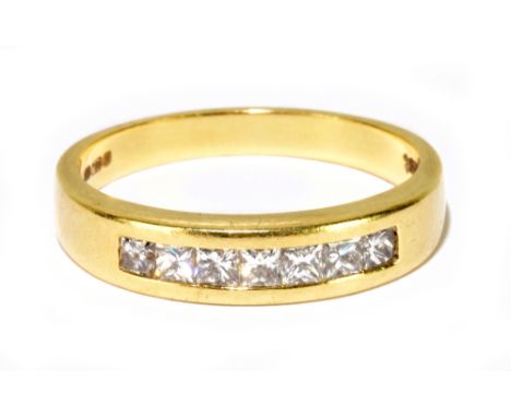 An 18ct yellow gold and seven stone diamond ring, the princess cut channel set stones totalling 0.50ct, size P 1/2, approx 5g