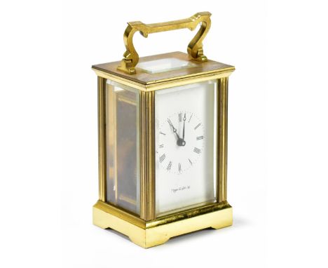 MAPPIN &amp; WEBB; a brass cased carriage clock, the enamel dial set with Roman numerals, height including swing handle 15cm.