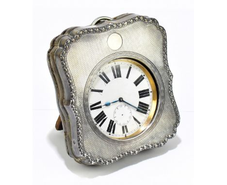 A George V hallmarked silver mounted easel backed Goliath watch holder, with cast rim and engine turned decoration surroundin
