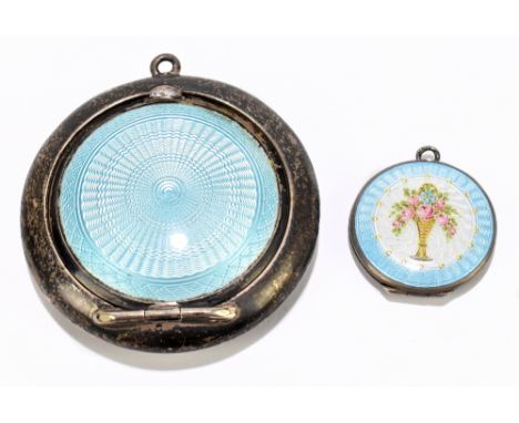 A George V silver and enamel circular compact, Birmingham 1922, diameter 5cm, with a smaller white metal and enamel locket (2