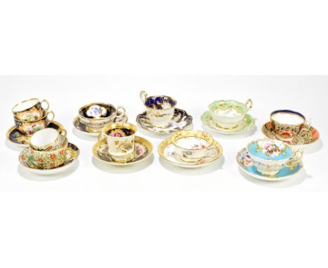 A collection of 19th century tea cups and saucers including two trios, one example possibly Derby, decorated with an eagle an