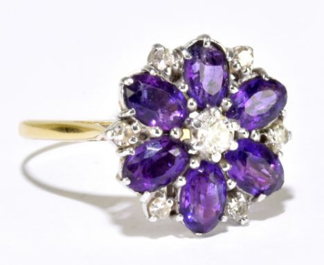 An 18ct yellow gold diamond and amethyst flowerhead ring, stepped with six oval amethysts and seven round brilliant cut diamo