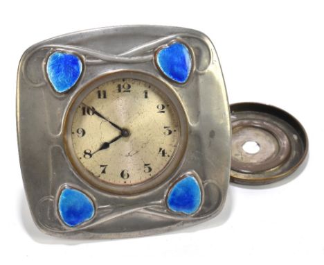 ARCHIBALD KNOX (1864-1953) FOR LIBERTY &amp; CO; a Tudric pewter easel back timepiece set with four enamel cabochons flanking