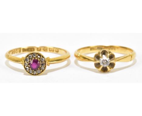 An early 20th century 18ct yellow gold ring, with central ruby coloured stone within a band of melee diamonds (one missing), 