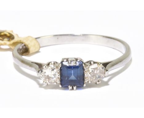 A platinum sapphire and diamond three stone ring, with central square cut sapphire flanked by twin round brilliant cut diamon