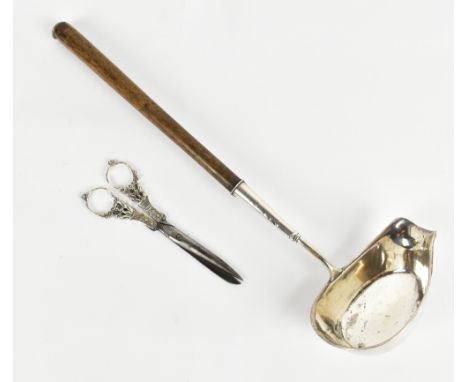 A white metal sauce ladle with turned wooden handle, length 39cm, and a pair of scissors with white metal mounts (2).