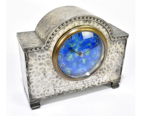 CASTLE PEWTER; an Arts & Crafts pewter and enamelled domed mantel clock, with hammered case and Arabic numerals to the circul