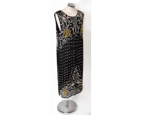 A 1920s long black silk sleeveless tunic embellished with decorative sequins, bugle beads and faux pearls, with a round neckl