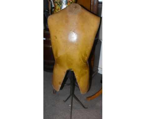 A vintage hardened rubber military mannequin raised on simple metal support to tripod base, unnamed, height 110cm.