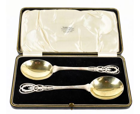 ADIE BROTHERS; a pair of George V hallmarked silver and parcel gilt serving spoons, Birmingham 1924, weight 4ozt/138g, cased.