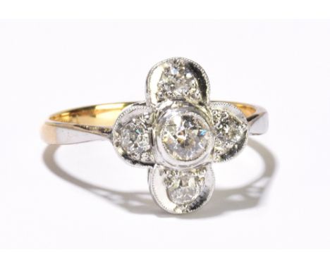 An 18ct yellow gold diamond quatrefoil ring, the central collet set old cut diamond weighing approximately 0.25cts, with four