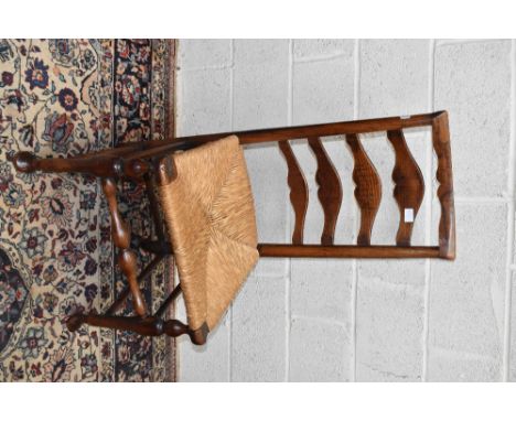 A 19th century rush seated ladder back chair, on pad feet, height 101cm.