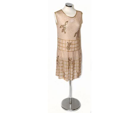 A 1920s cream silk beaded sleeveless flapper dress, completely covered with gold mercury and bugle beads to front and back, w