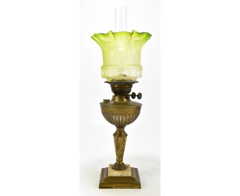 An early 20th century oil lamp with green frosted glass shade, on stepped plinth vase, height including chimneys 59cm.Additio