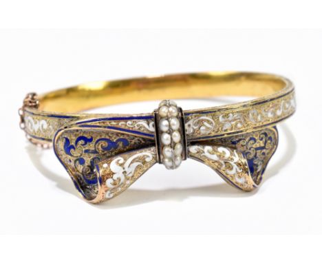 A yellow metal enamel decorated and cultured pearl set oval hinged snap bangle, with engraved detail throughout, interior wid