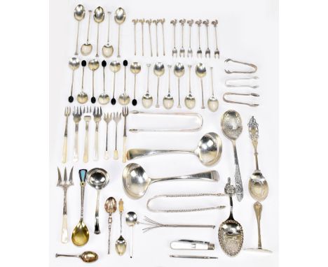 An assortment of silver and white metal spoons, tongs and cocktail sticks, to include a pair of Old English pattern sauce lad