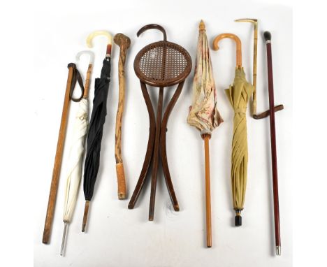 Three vintage 1950s umbrellas, two with cane handles, a riding crop with carved antler handle, two walking sticks and an earl