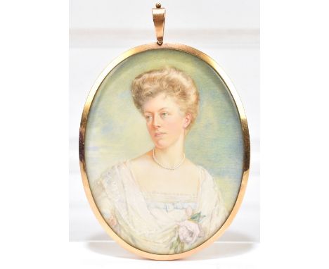 An Edwardian miniature portrait on ivory, the female sitter wearing a lace trimmed white dress embellished with roses, in a y