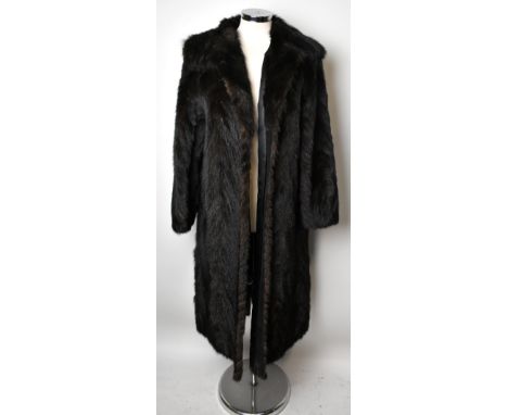 A full length dark brown mink coat with large collar, front closures, two front slip pockets and cuffed sleeves and lined in 