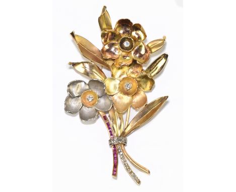A large three tone yellow metal diamond and ruby floral spray brooch, the central stem set with eleven eight cut diamonds tot