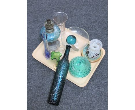 A tray of assorted antique and later glass ware to include a pewter oil lamp with blue glass reservoir, studio glass vases, e