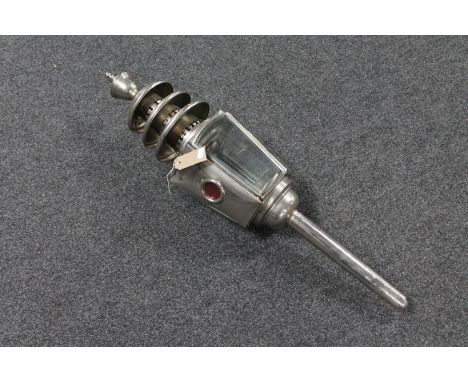 An antique chrome coach lamp