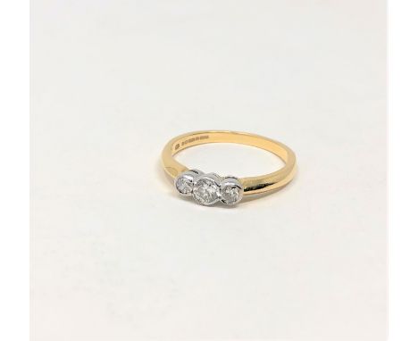 An 18ct gold three stone diamond ring, the stated total diamond weight 0.43 carat, size Q