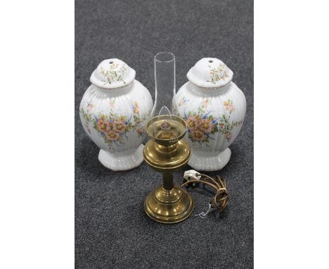 A brass oil lamp with chimney (converted) together with a pair of pottery lamp bases 