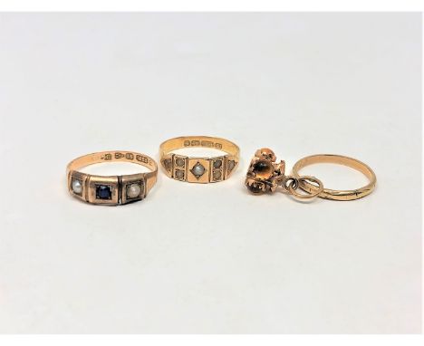 An 18ct gold band ring, two 15ct gold pearl set rings and a yellow metal charm CONDITION REPORT: 18ct - 1.6g. 15ct - 3.4g. Ch