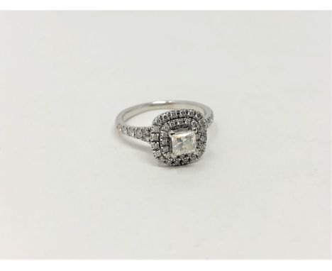 An 18ct white gold diamond cluster ring, the central princess cut stone of 0.46ct, clarity VS2, Colour G, with Maple Leaf Dia