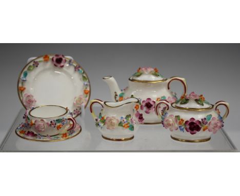 A Coalport floral encrusted miniature part tea service, 20th century, comprising teapot and cover, jug, sucrier and cover, te