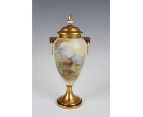 A Royal Worcester two-handled vase and cover, dated 1933, the tapered body painted by H. Stinton, signed, with deer in a moun