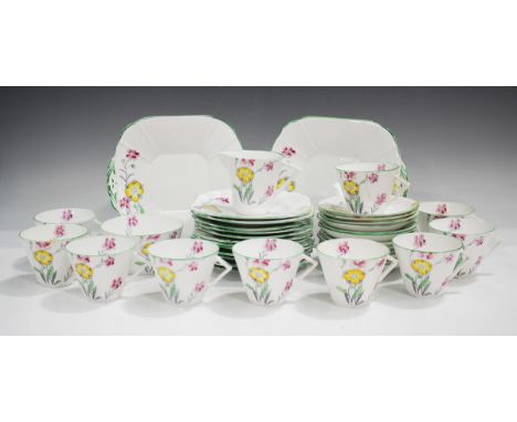 An Art Deco Melba bone china part tea service, decorated with flowers, comprising two cake plates, ten teacups and twelve sau