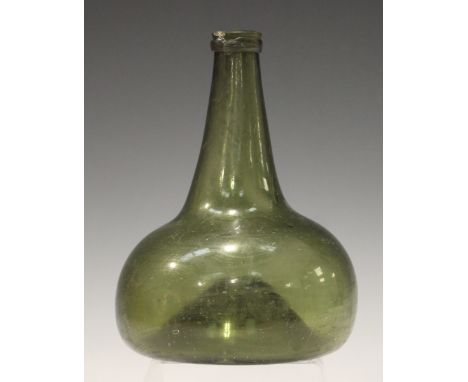 A Dutch green glass onion wine bottle, circa 1720-40, height 18.5cm, together with the Antique Collectors' Club reference boo