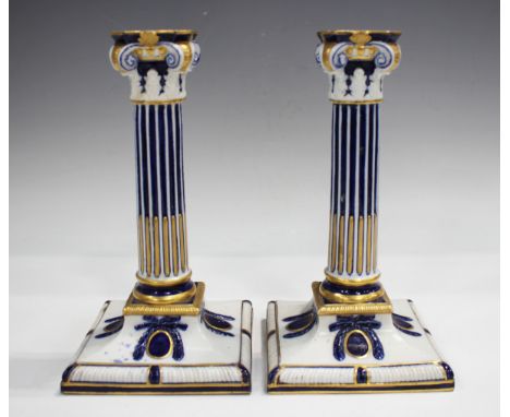 A pair of Royal Worcester porcelain Corinthian column candlesticks, circa 1862-1875, each with blue and gilt decoration, impr