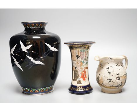 A Japanese black ground ‘cranes’ cloisonné enamel vase, 18.3cm, a Satsuma pottery vase and a crane decorated jug (3)