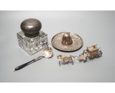 A silver mounted glass inkwell, A Mexican white metal miniature sombrero, a white metal caddy spoon and a filigree horse and 