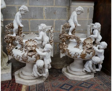 A pair of composition faux marble cherub and mask jardinieres, height 112cm