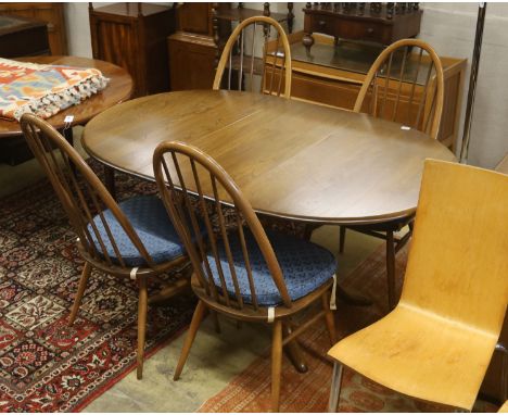 An Ercol elm oval extending dining table, 148cm extended, width 97cm, height 74cm, together with a pair of Ercol elm and beec