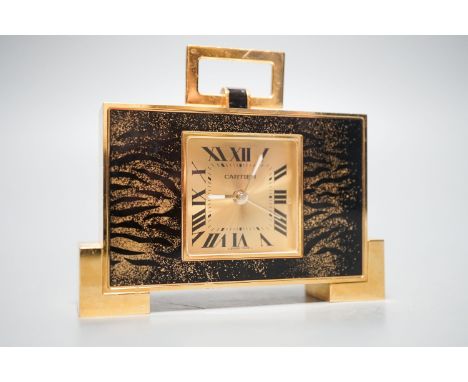 A cased Cartier gilt metal travelling clock, 10.5 cm wide, with certificate booklet