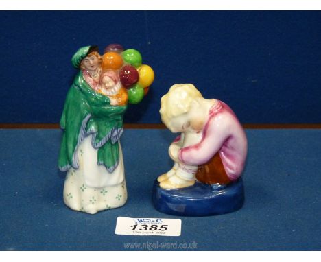 A miniature Doulton figure 'The Balloon Seller' 4'' tall, plus a Royal Worcester 'sleeping boy' figure after F.G. Doughty, 3'