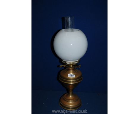 A brass oil lamp and white globe shade, 21 1/4".